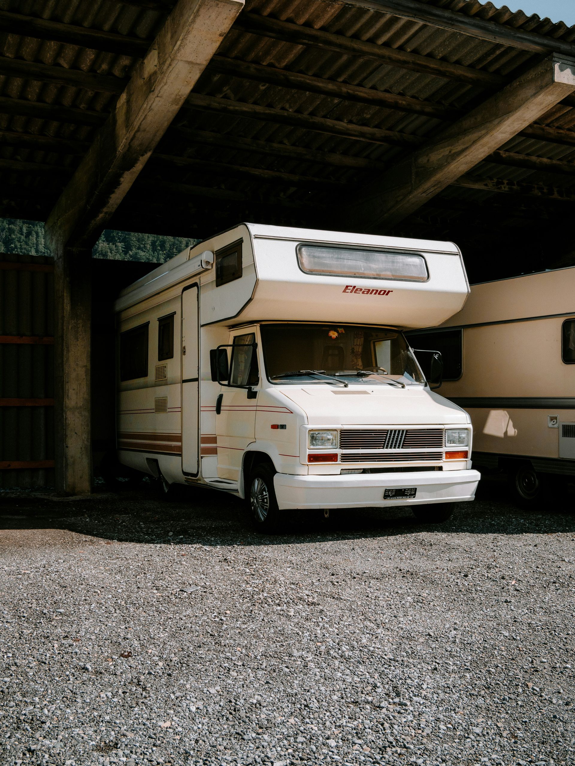 A couple of rvs parked in a garage